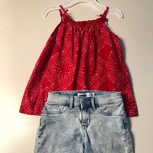 Girl’s polka dot top with jean shorts.